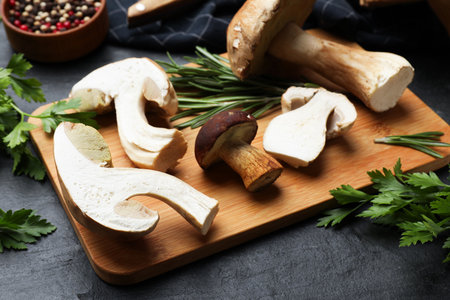 Fresh porcini mushrooms and spices on black table, closeupの写真素材