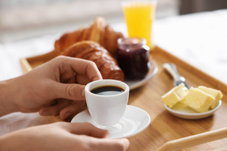 Man having breakfast in bed, closeup. Hotel room serviceの写真素材