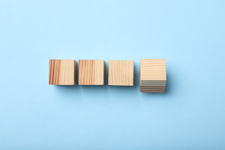 Wooden cubes on light blue background, top viewの写真素材