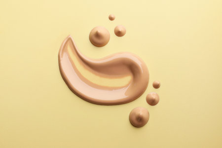 Samples of foundation on beige background, flat layの写真素材