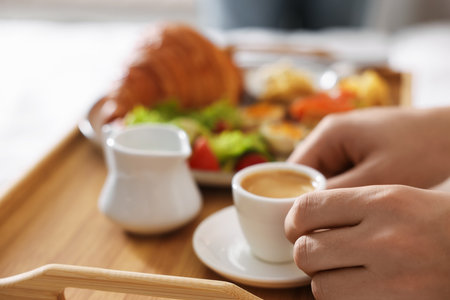 Man having breakfast in bed, closeup.の写真素材