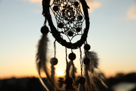 Shamanism. Beautiful dream catcher hanging outdoors, closeupの写真素材