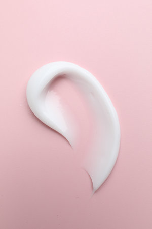 Sample of moisturizing cream on pink background, top viewの写真素材
