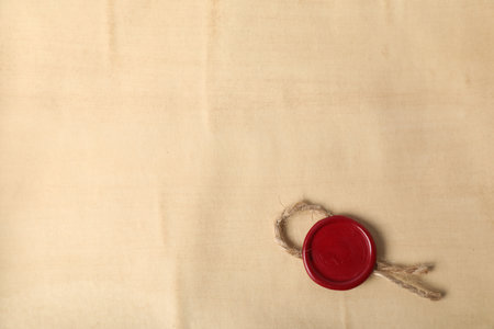 Old parchment paper with wax seal as background, top viewの写真素材