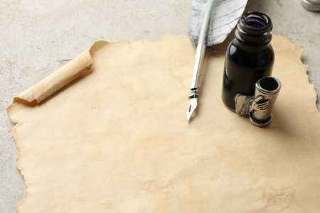 Blank old paper, fountain pen and inkwell on light gray table, closeup. Mockup for designの写真素材