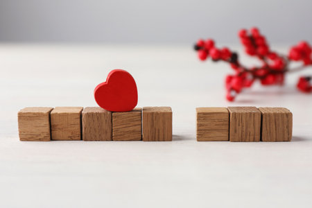 Blank wooden cubes and decorative heart on white table. Mockup for designの写真素材