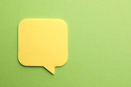 Blank paper note on green background, top view. Mockup for designの写真素材