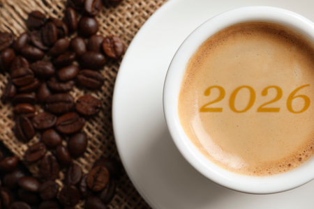 Hello New 2026 Year. Cup of coffee with numbers and roasted beans on table, top viewの写真素材