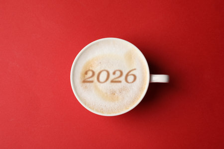 Cup of coffee with numbers on red background, top viewの写真素材