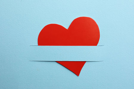 Red paper heart on light blue background, top view, Space for textの写真素材
