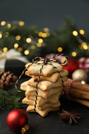 Christmas composition with fir tree branches, festive decor and cookies on black table, closeupの写真素材