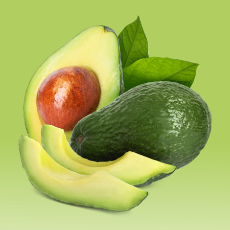 Fresh avocados and leaves on green gradient backgroundの写真素材