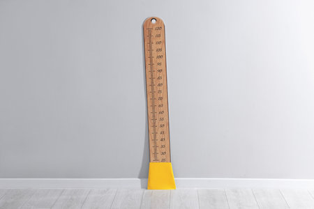 Height measuring chart on light gray wall indoors