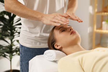 Reiki master healing patient's aura during therapy indoors, closeupの写真素材