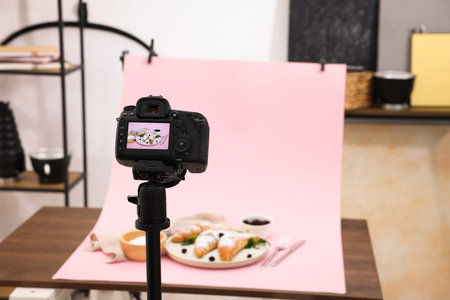 Shooting tasty croissants and ingredients with camera in studio, selective focus. Professional food...