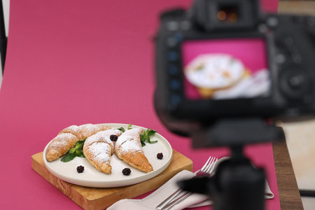 Shooting tasty croissants with camera in studio, selective focus. Professional food photographyの写真素材