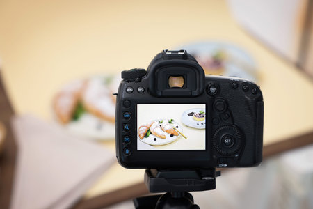 Shooting tasty pastries with camera in studio, selective focus. Professional food photography