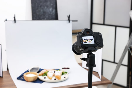 Shooting tasty croissants and ingredients with camera in studio, selective focus. Professional food photographyの写真素材