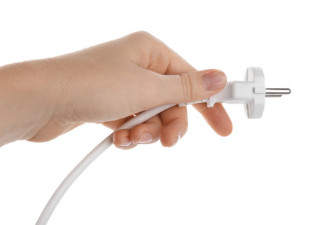 Woman holding electrical wire with plug on white background, closeupの写真素材