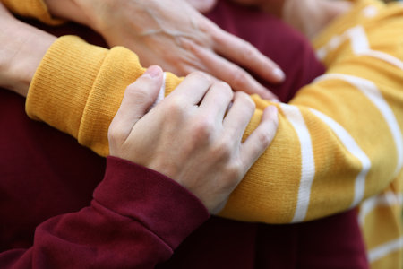 Mother and son hugging outdoors, closeup. Family bondingの写真素材