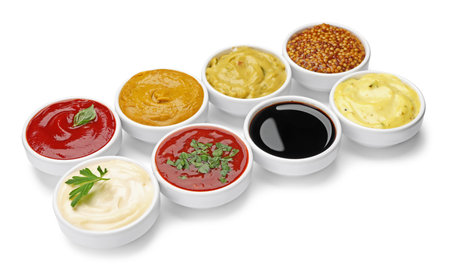 Different sauces and herbs isolated on white