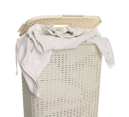 Laundry basket with clothes isolated on whiteの写真素材