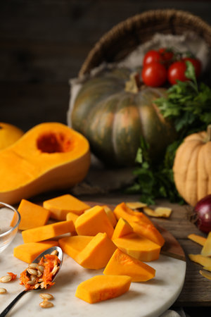Fresh pumpkins, seeds, peels and ingredients on wooden table, closeupの写真素材