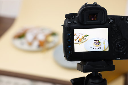 Shooting tasty pastries with camera in studio, selective focus. Professional food photographyの写真素材