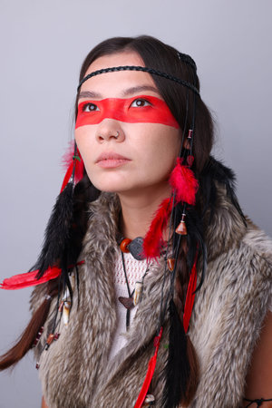 Shaman woman with face painting on light gray background