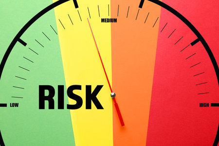 Scale with arrow indicating level of risk on colorful backgroundの写真素材