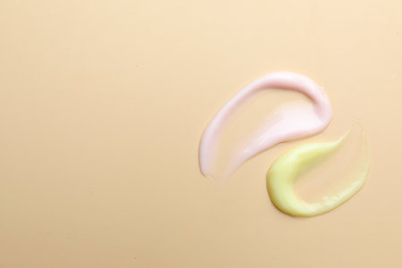 Samples of different cosmetic products on beige background, flat lay. Space for textの写真素材