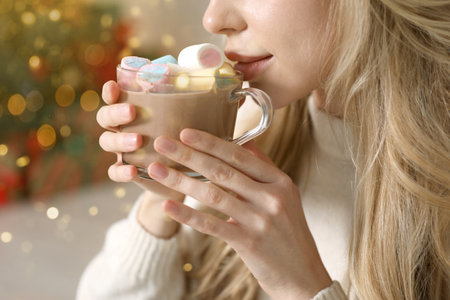 Woman drinking tasty cocoa at home, closeup. Christmas vibesの写真素材