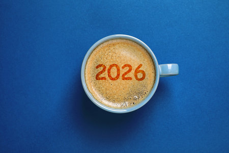 Cup of coffee with numbers on blue background, top view