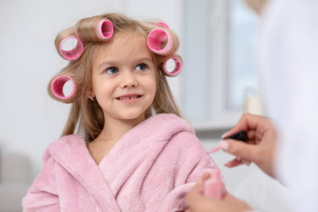 Mom doing her daughter's nails at home, closeupの写真素材