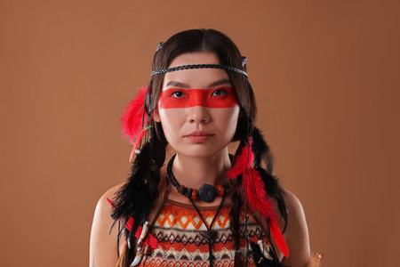 Shaman woman with face painting on brown background