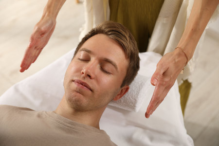 Reiki master healing patient's aura during therapy indoors, closeupの写真素材