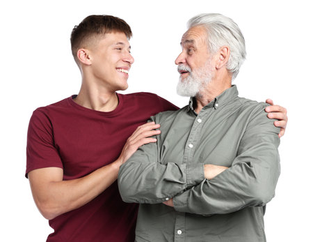 Son hugging his father on white backgroundの写真素材
