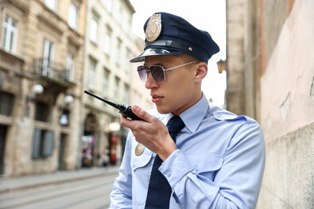 Police officer talking via radio on city street
