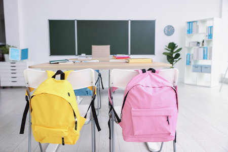 Green chalkboard and stylish furniture in classroom. Mockup for designの写真素材