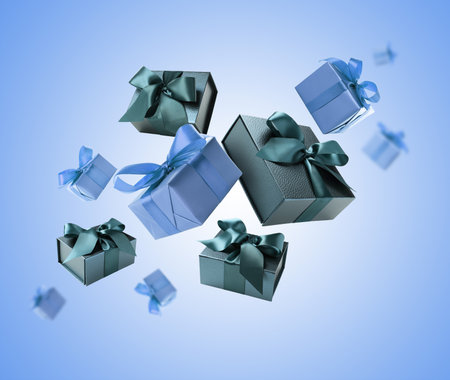 Gift boxes flying in air on blue gradient backgroundの写真素材