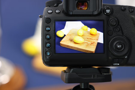 Shooting fresh lemons and juicer with camera in studio, selective focus. Professional food photographyの写真素材