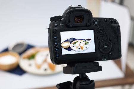 Shooting tasty croissants and ingredients with camera in studio, selective focus. Professional food...