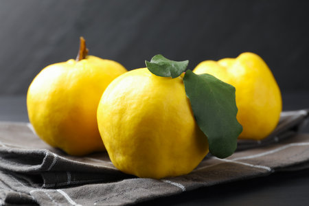 Fresh ripe quinces on black wooden table, closeupの写真素材