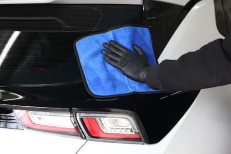 Man wiping auto with rag at car wash, closeupの写真素材