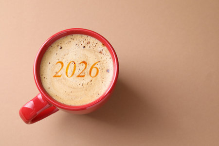 Cup of coffee with numbers on beige background, top view. Space for textの写真素材