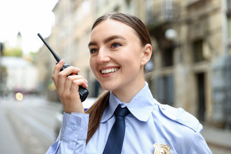 Police officer talking via radio on city streetの写真素材
