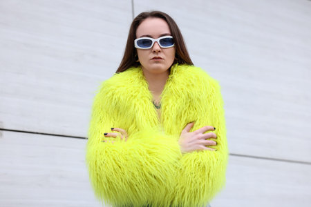 Young woman with piercings, tattoos and stylish clothes outdoorsの写真素材