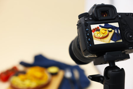 Shooting chicken nuggets, French fries, sauces and tomatoes with camera in studio, selective focus. Professional food photographyの写真素材