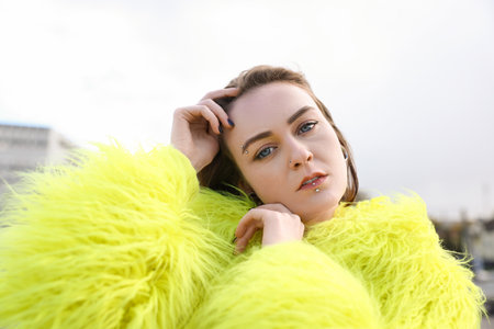 Young woman with piercings and stylish clothes outdoorsの写真素材