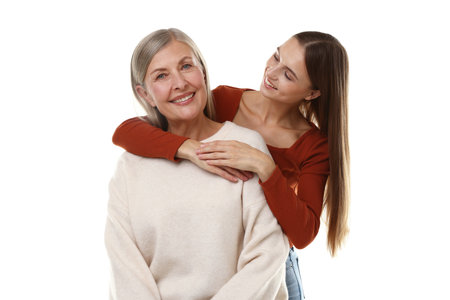 Daughter hugging her mother on white background